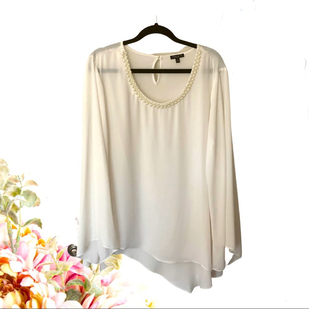 White blouse with pearl detail around neckline